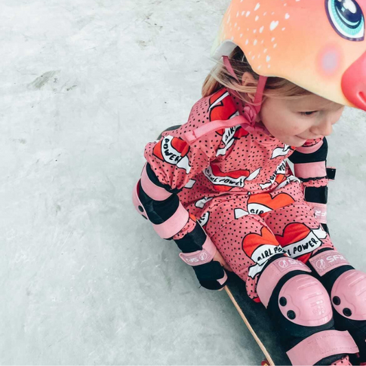 Organic toddler pullover top - girl power pink hearts - on model riding skateboard