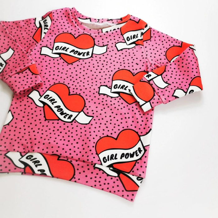 Organic toddler pullover top - girl power pink hearts -  flat lay sleeve fold view