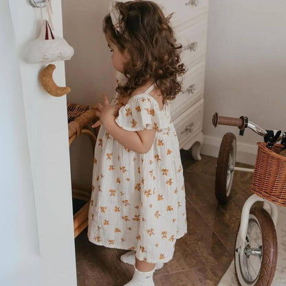 Haven Organic Baby / Toddler Floral Dress - Ecru on Model Standing in Nursery
