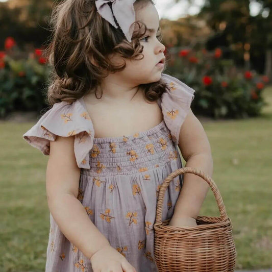 Haven Toddler Organic Floral Dress - Lavender ruffle and chest detail on model