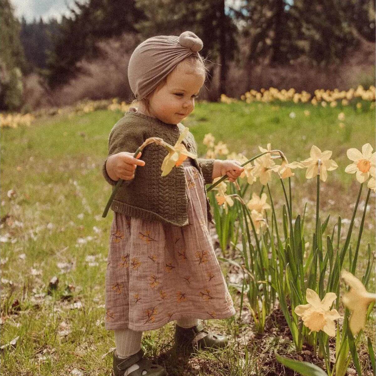 Haven Toddler Organic Floral Dress - Lavender on model baby standing in meadow