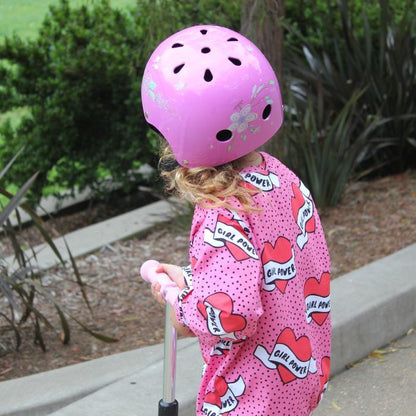 Organic toddler pullover top - girl power pink hearts - back view on model riding scooter